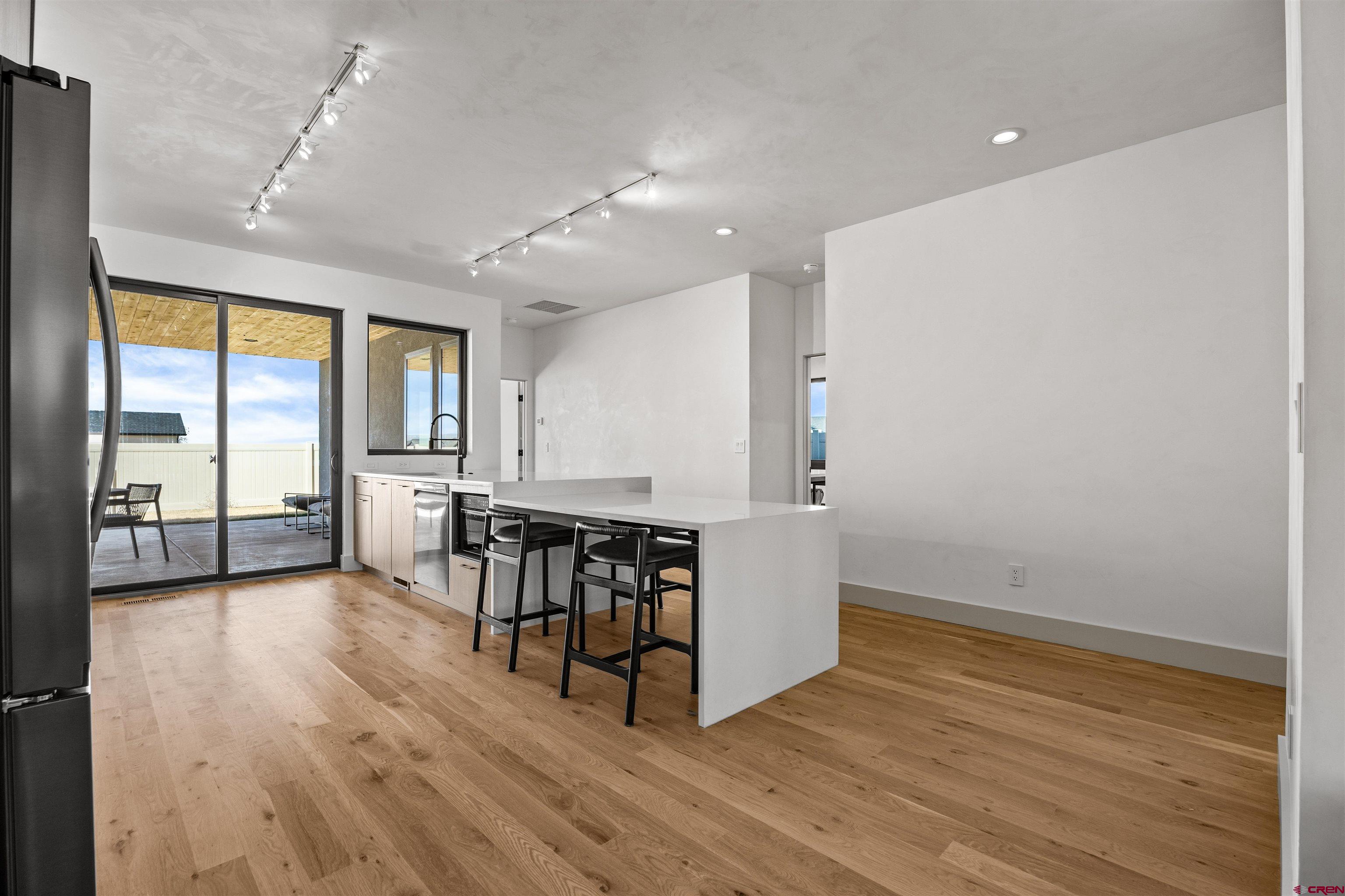 3435 Kestrel Loop Montrose, CO 81401 - Photo 12 of 34 a view of a room with furniture and wooden floor