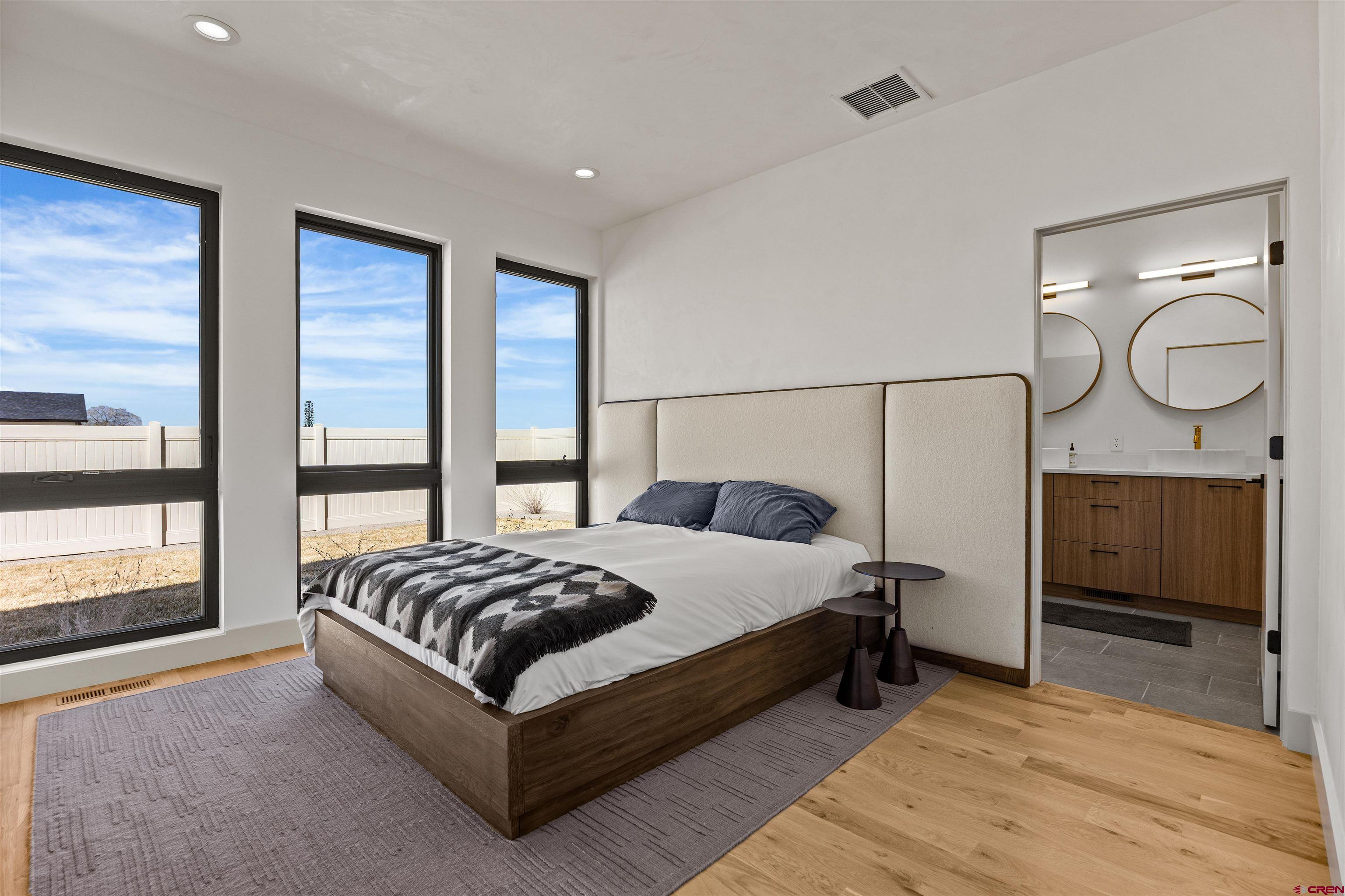 3435 Kestrel Loop Montrose, CO 81401 - Photo 14 of 34 a spacious bedroom with a bed and large window