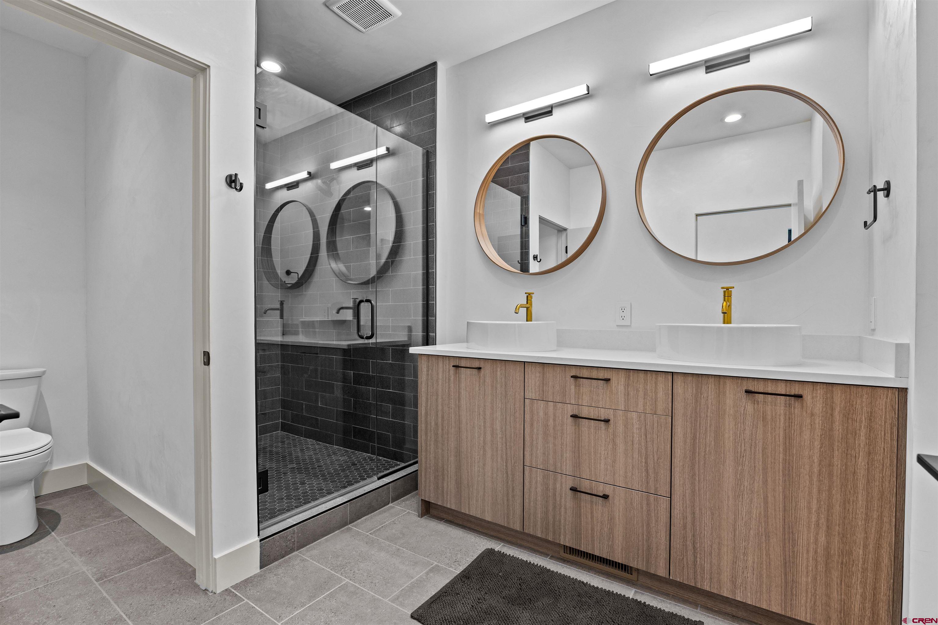 3435 Kestrel Loop Montrose, CO 81401 - Photo 16 of 34 a bathroom with a sink a toilet and a mirror