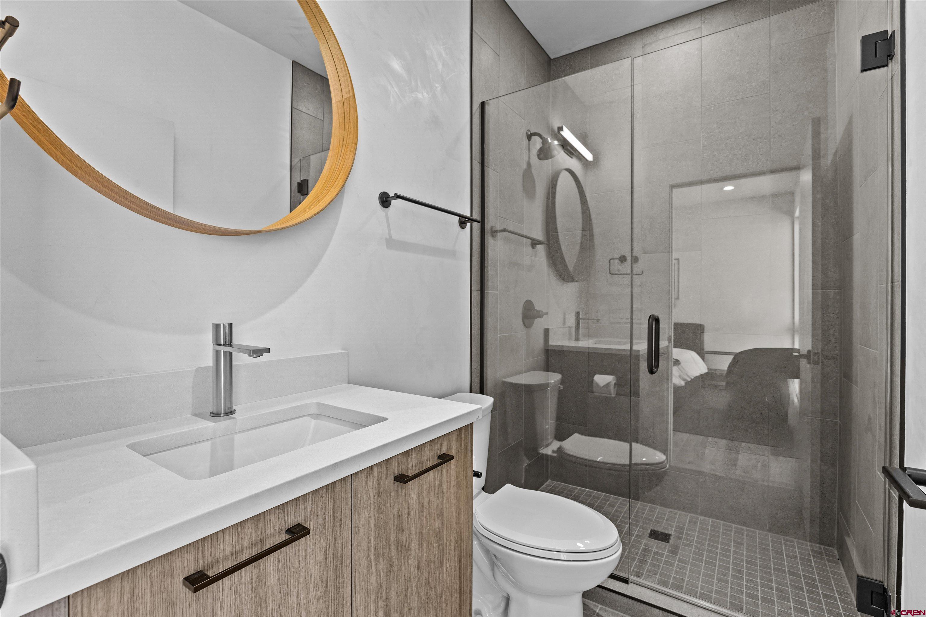 3435 Kestrel Loop Montrose, CO 81401 - Photo 21 of 34 a bathroom with a sink a toilet and shower