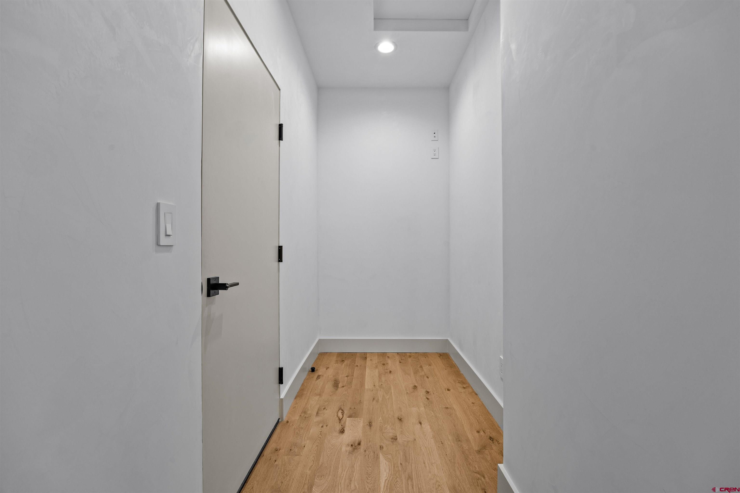 3435 Kestrel Loop Montrose, CO 81401 - Photo 27 of 34 a view of a hallway with wooden floor