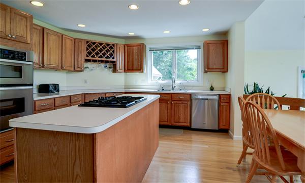 5 Garvey Road Framingham, MA 01701 - Photo 8 of 30 a kitchen with stainless steel appliances a sink a stove a refrigerator cabinets and a dining table