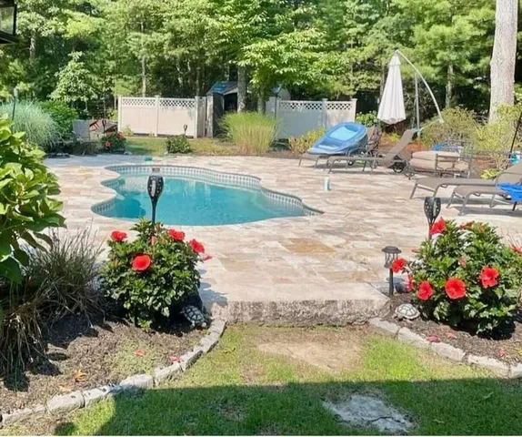a view of a house with a yard and sitting area