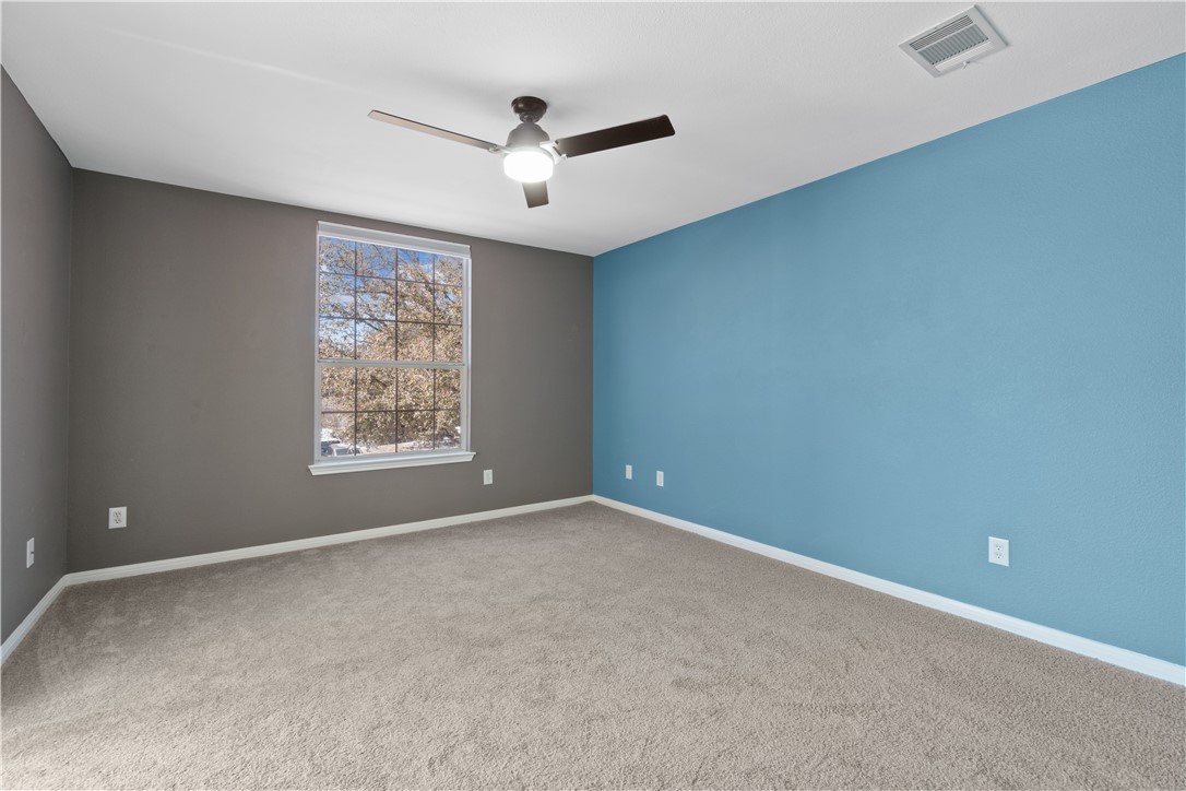1533 Lorson Loop Round Rock, TX 78665 - Photo 13 of 27 an empty room with windows and fan