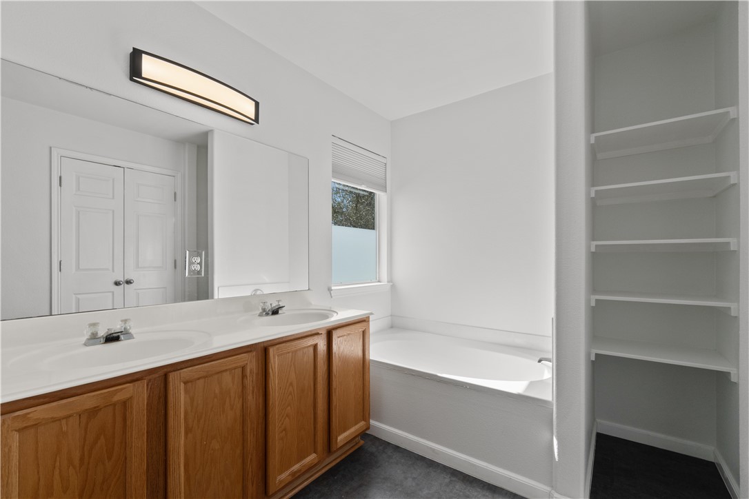 1533 Lorson Loop Round Rock, TX 78665 - Photo 16 of 27 a bathroom with a tub sink and a mirror