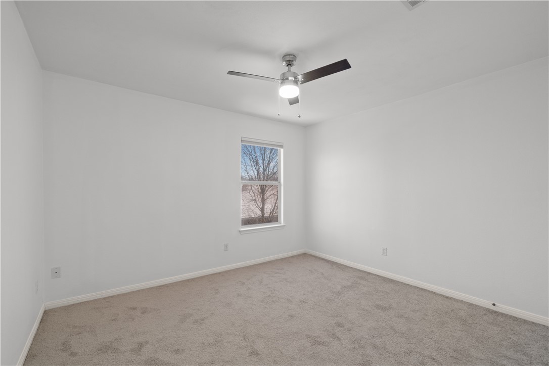 1533 Lorson Loop Round Rock, TX 78665 - Photo 19 of 27 an empty room with a window and ceiling fan