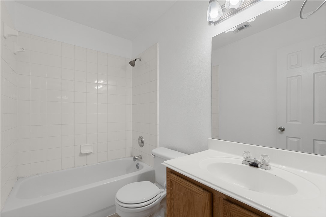 1533 Lorson Loop Round Rock, TX 78665 - Photo 21 of 27 a bathroom with a sink a toilet and shower