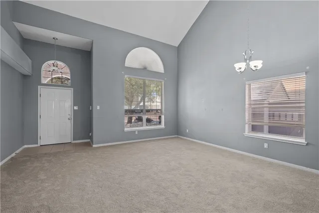 a view of an empty room with a fireplace and a window