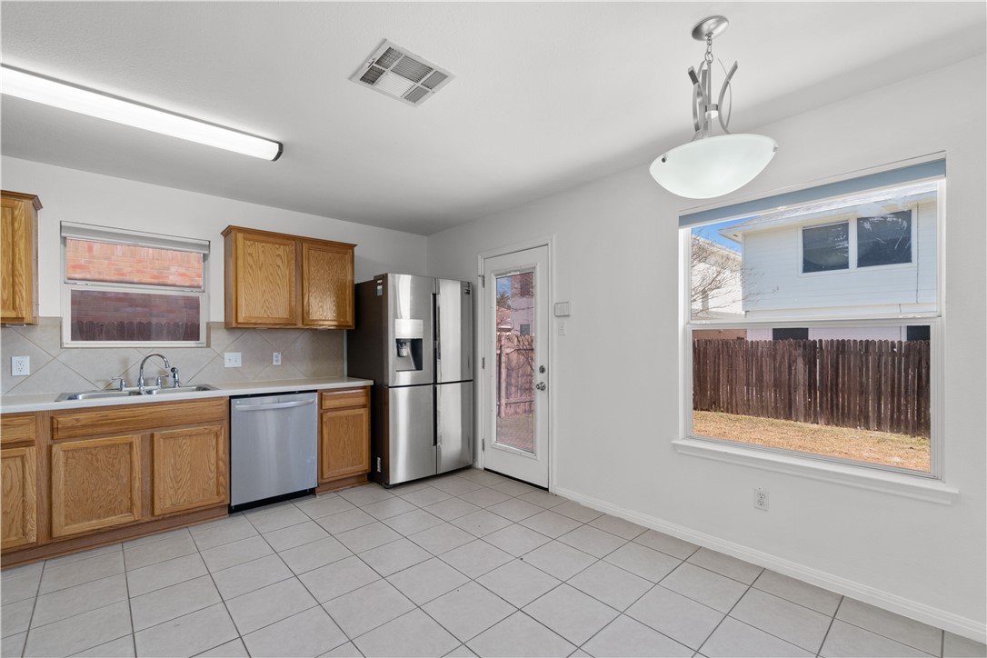 1533 Lorson Loop Round Rock, TX 78665 - Photo 8 of 27 a kitchen with stainless steel appliances granite countertop a stove a sink and a refrigerator