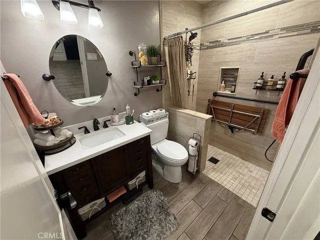 a bathroom with a sink mirror toilet and shower