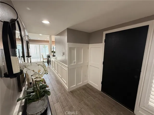 a view of a kitchen with wooden floor and electronic appliances