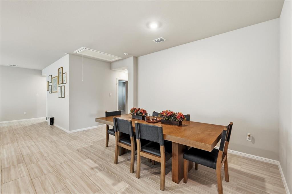 5344 Flannel Lane Krum, TX 76249 - Photo 12 of 40 a view of a dining room with furniture and wooden floor