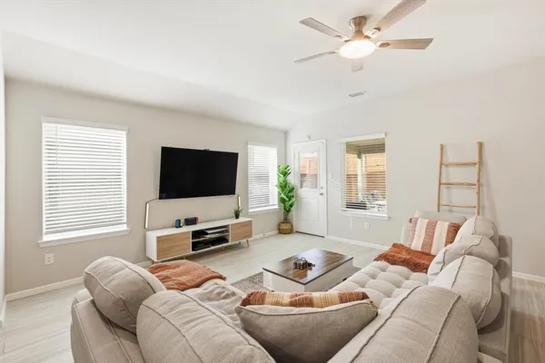 a living room with furniture and a flat screen tv