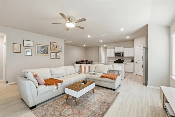 a living room with furniture and kitchen view