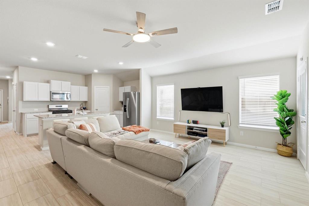 5344 Flannel Lane Krum, TX 76249 - Photo 22 of 40 a living room with furniture and a flat screen tv