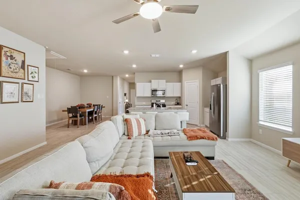 a living room with furniture and kitchen view