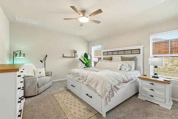 a bedroom with a large bed and a chandelier