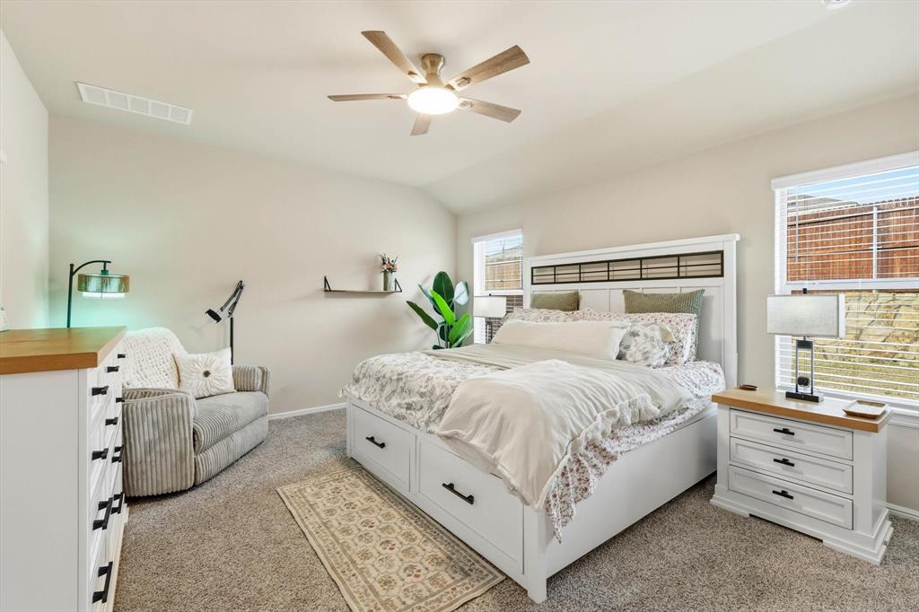 5344 Flannel Lane Krum, TX 76249 - Photo 25 of 40 a bedroom with a large bed and a chandelier