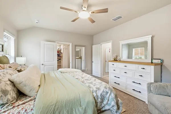 a bedroom with a bed and ceiling fan