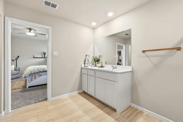 a en suite bathroom with a sink and a mirror