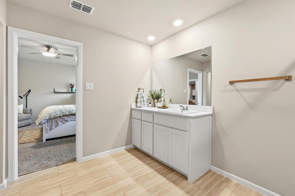 5344 Flannel Lane Krum, TX 76249 - Photo 28 of 40 a en suite bathroom with a sink and a mirror