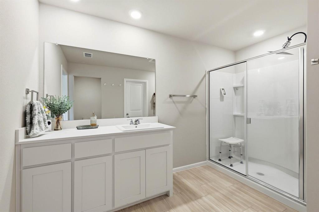 5344 Flannel Lane Krum, TX 76249 - Photo 30 of 40 a en suite bathroom with a double vanity sink mirror and shower