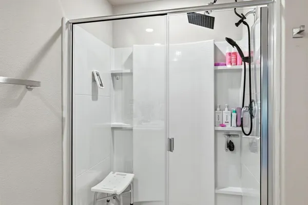 a bathroom with a shower and a sink