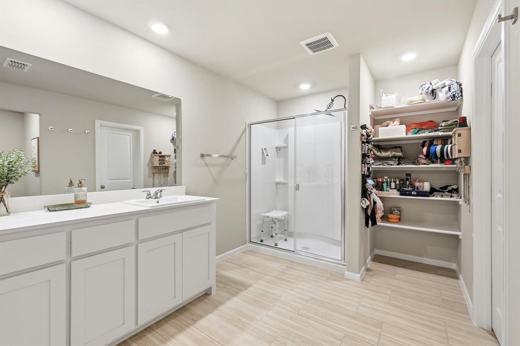 5344 Flannel Lane Krum, TX 76249 - Photo 32 of 40 a bathroom with a shower sink and mirror