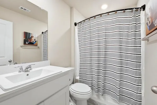 a bathroom with a sink a toilet and mirror