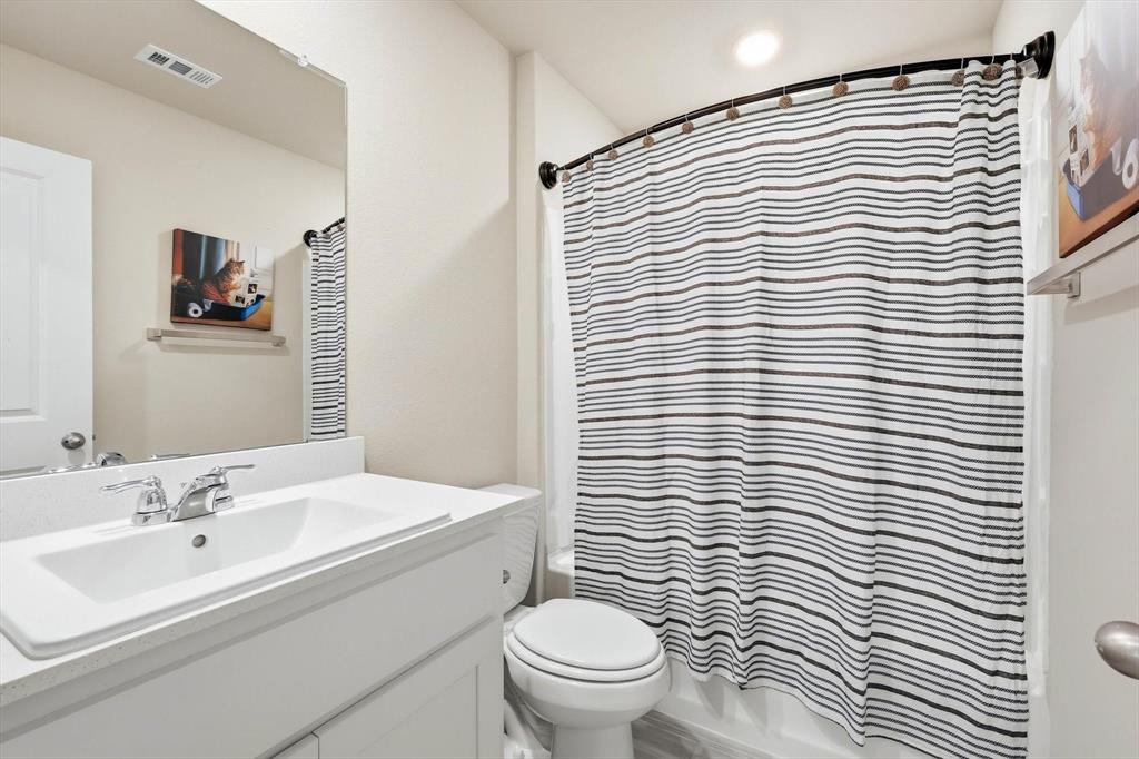 5344 Flannel Lane Krum, TX 76249 - Photo 35 of 40 a bathroom with a sink a toilet and mirror