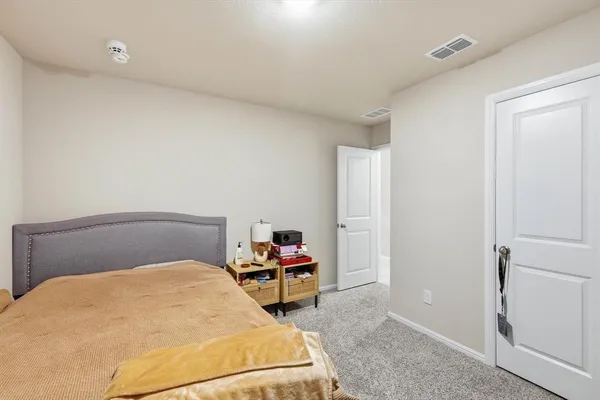 a bedroom with a bed and chair