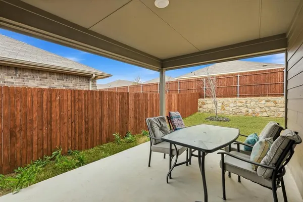a view of a patio with a table and chairs