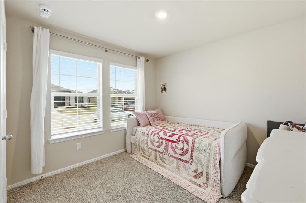 5344 Flannel Lane Krum, TX 76249 - Photo 4 of 40 a bedroom with a bed and a window