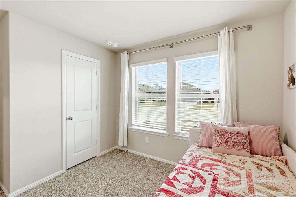 5344 Flannel Lane Krum, TX 76249 - Photo 5 of 40 a bedroom with a large bed and a window
