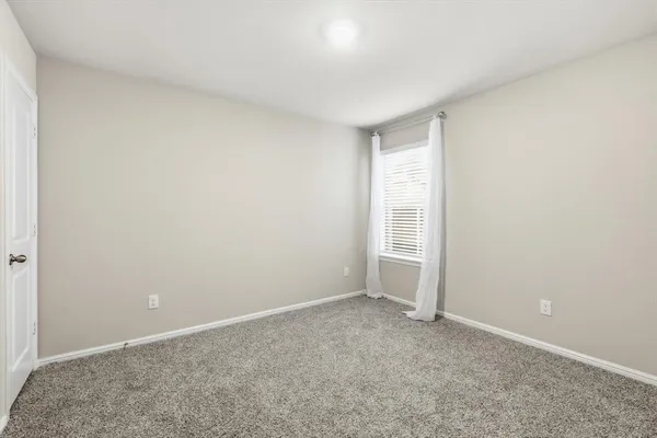 a view of an empty room with closet