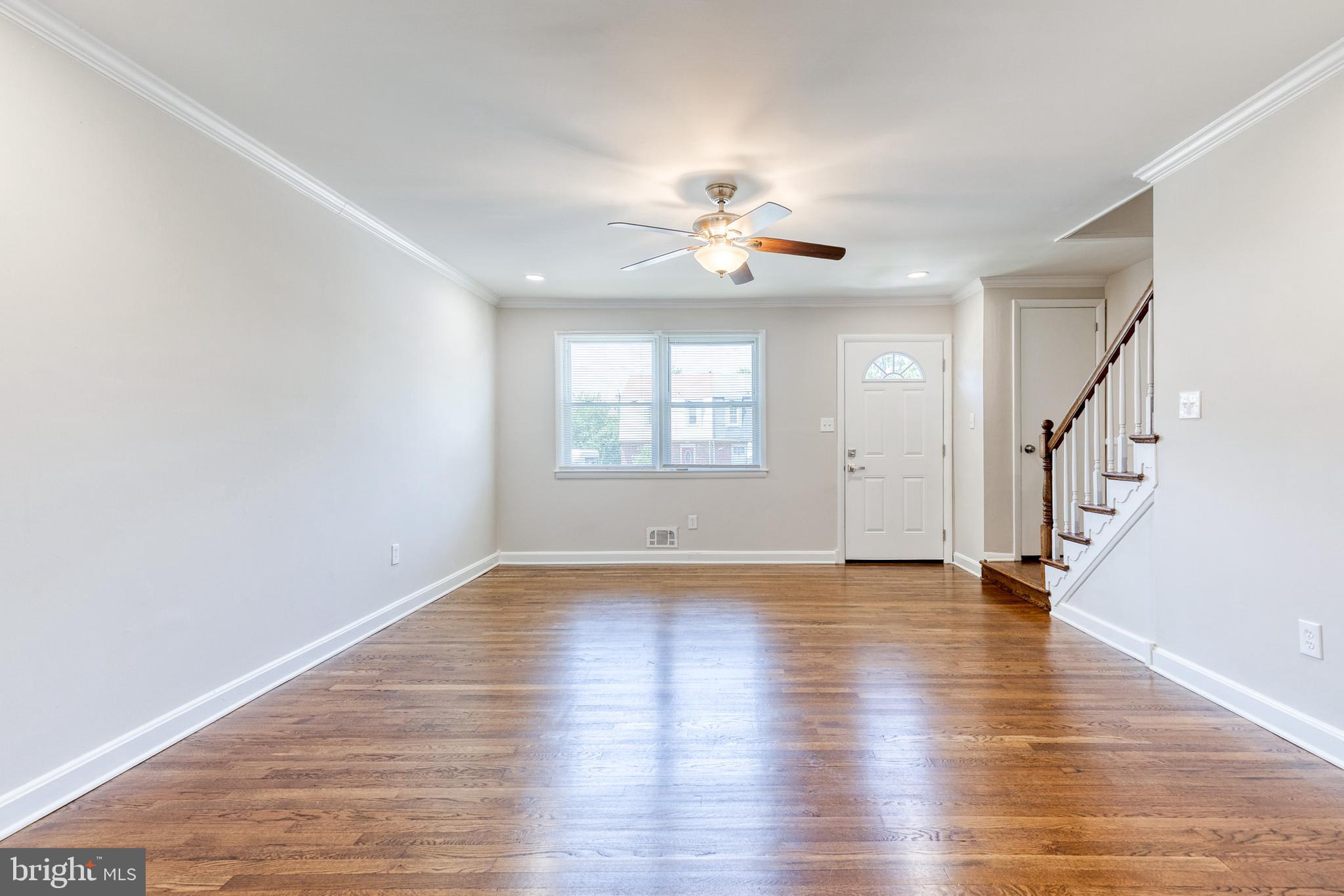 5649 Utrecht Road Baltimore, MD 21206 - Photo 7 of 42 a view of an empty room with wooden floor and a window