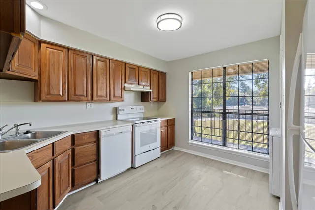 a kitchen with a sink stove and cabinets
