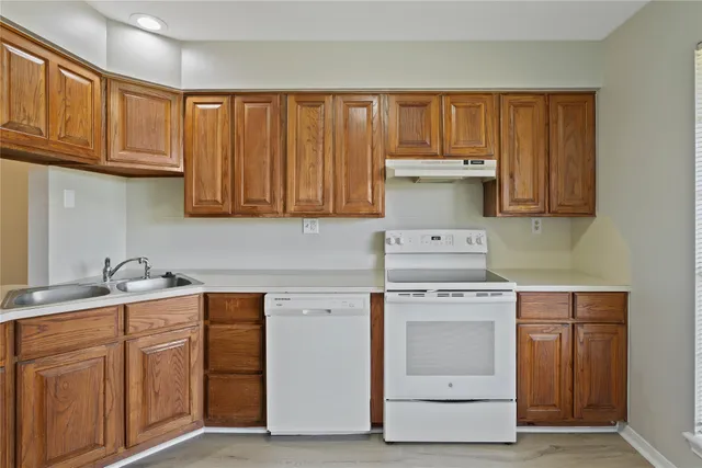 a kitchen with stainless steel appliances granite countertop a stove and a sink
