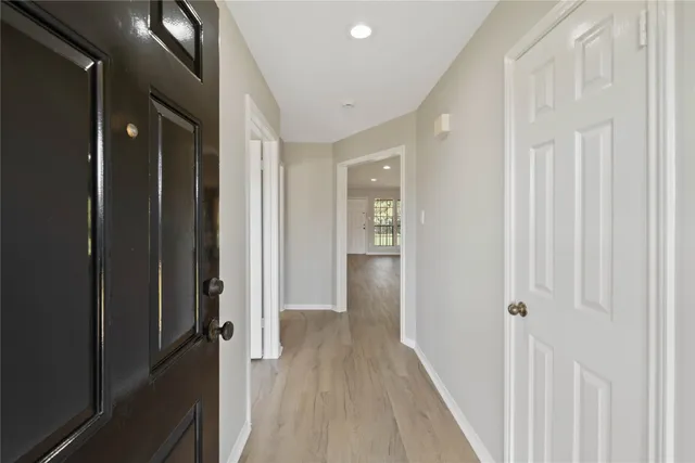 a view of a hallway with wooden floor