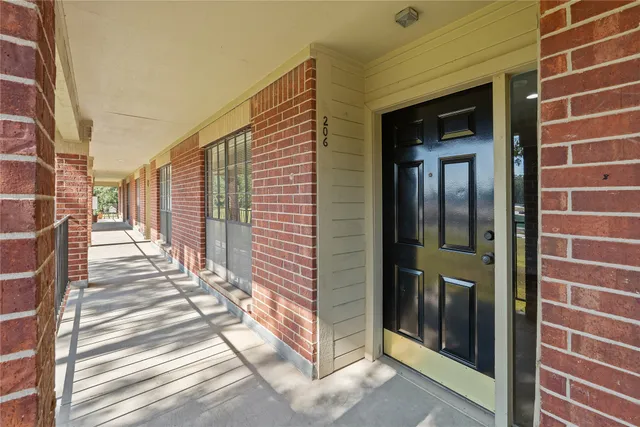 a view of a brick house with a glass door