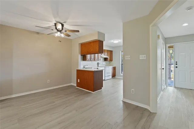 a view of a kitchen with a sink and a cabinet wooden floor