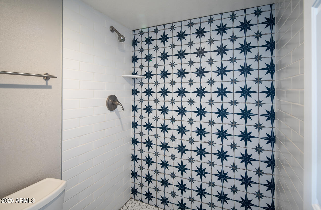 4540 North 44th Street, Unit 50 Phoenix, AZ 85018 - Photo 10 of 31 a bathroom with a shower curtain