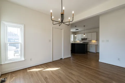 a view of a kitchen with a sink and wooden floor