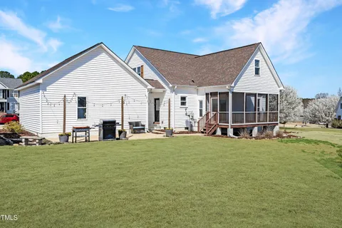 a view of a house with a yard and sitting area
