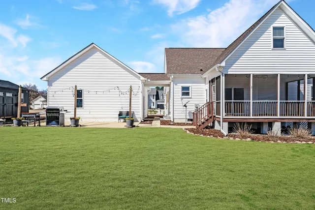 a view of a house with backyard porch and sitting area