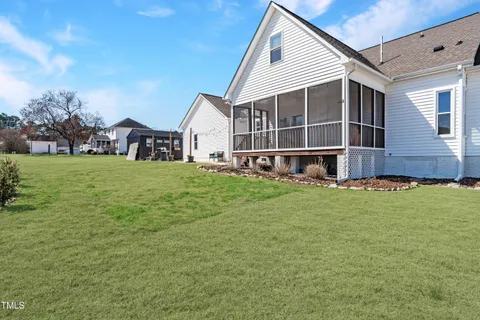 a view of a house with a yard and sitting area