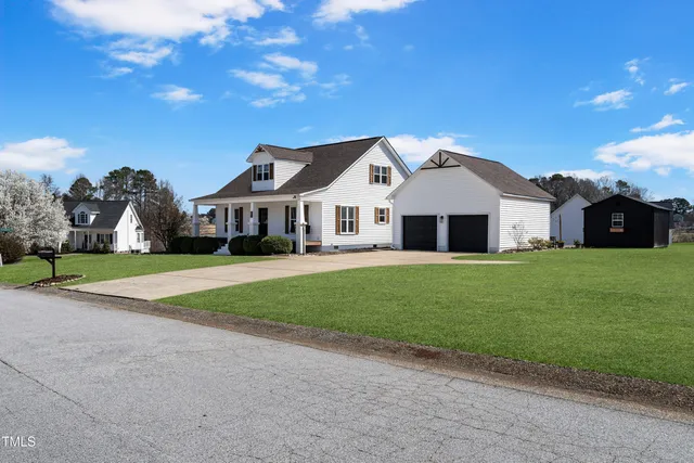 a front view of house with yard and green space