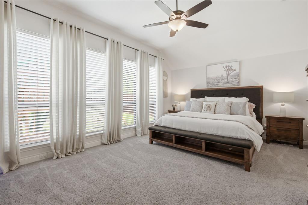 904 Fallbrook Avenue Denton, TX 76210 - Photo 18 of 30 a spacious bedroom with a bed and a chandelier