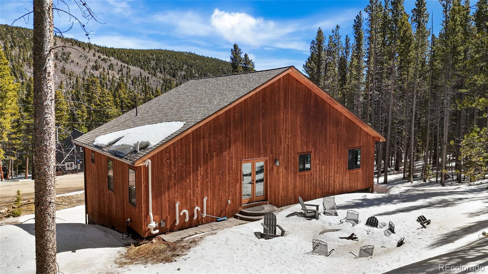 79 Beaver Road Idaho Springs, CO 80452 - Photo 41 of 48 a view of a barn in the middle of a yard