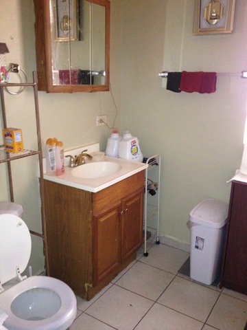 1842 South Drake Avenue Chicago, IL 60623 - Photo 20 of 25 a bathroom with a sink toilet vanity and mirror